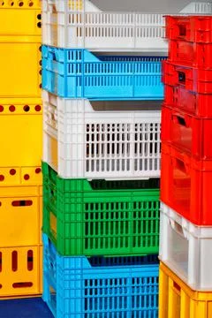 Plastic multi colored boxes stacked on top of each other. Foto stock