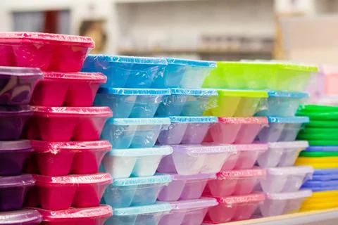 Plastic multi colored containers in store. Stock Photos