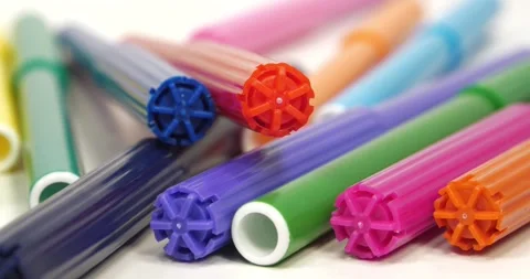 Plastic multi-colored felt-tip pens lie on white table Stock Footage 308654827