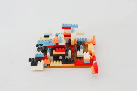 Plastic multi-colored jigsaw puzzle assembled by the idea. Stock Photos