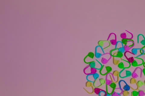 Plastic multi-colored knitting pins. colorful pins on the white background Stock Photos