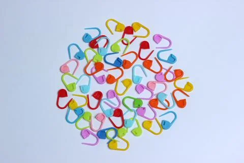 Plastic multi-colored knitting pins. colorful pins on the white background Stock Photos