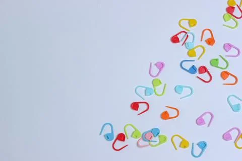 Plastic multi-colored knitting pins. colorful pins on the white background Stock Photos