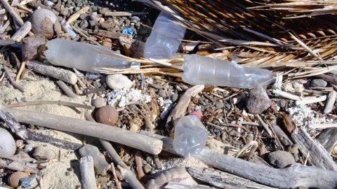 Plastic ocean plastic water bottles and debris washed ashore from sea on beach Stock Footage 342949058