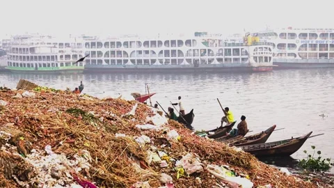 Plastic organic waste pollution along the banks Buriganga River in Dhaka Stock Footage 346512920