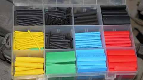 A plastic organizer box filled with colorful heat shrink tubing. Stock Footage 345909210