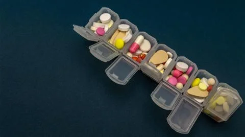 Plastic organizer for tablets. tablets are red, white, round. close-up Stock-Fotos