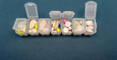 Plastic organizer for tablets. tablets are red, white, round. close-up Stock Photos