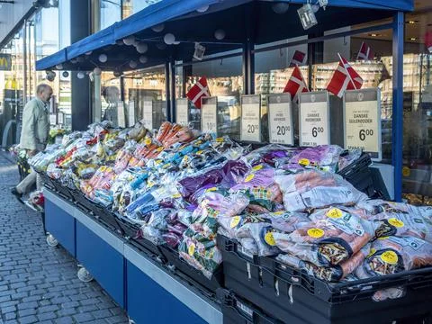 Plastic packages of fresh vegetables on display outside a grocery shop Stock Photos