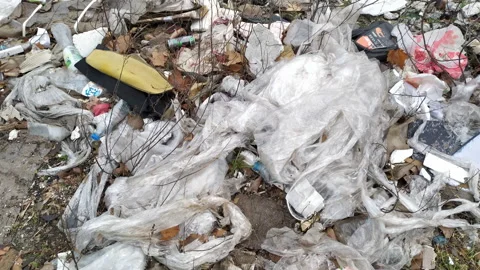 Plastic packaging and wrapping: abandoned bags and bottles on a field - open Stock Footage 233254614