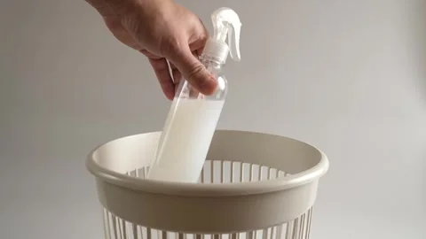 The plastic packaging from the detergent is thrown into the trash for recycli Stock Footage 260601848