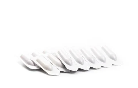 Plastic packs of suppositories on white  background - Image Stock Photos