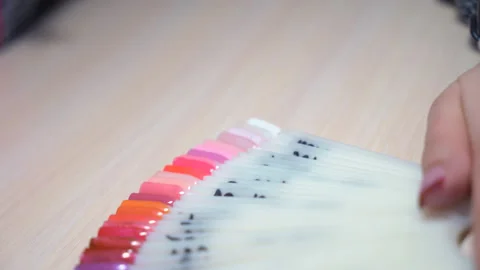 Plastic palette with artificial nails. Large selection of colors for nail Video stock 86939853