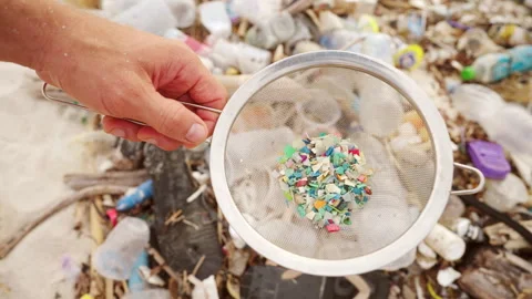Plastic particles or microplastics on a polluted beach, water pollution, ocean Stock Footage 306723231