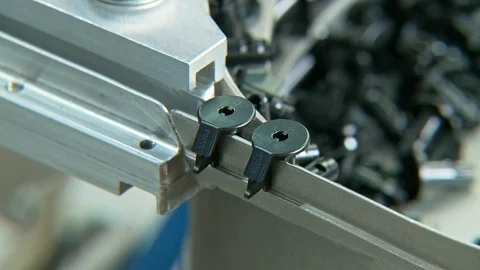 Plastic parts on a conveyor in an assembly machine Stock Footage 115293288