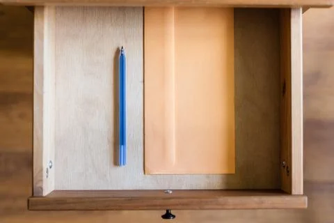 Plastic pen and envelope in open drawer Stock Photos