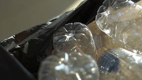 Plastic PET bottle in trash bag, dolly shot slow motion Stock Footage 123958859