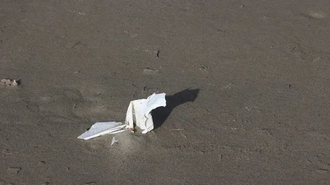 Plastic pieces fly anchored on the beach Video stock 84829573