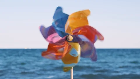 Plastic pinwheel rotating blowing wind stands  sand sea Stock Footage 105688424
