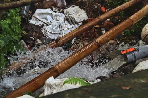 A plastic pipe that emits a very large discharge of fresh water. Stock Photos