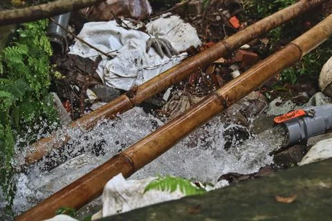 A plastic pipe that emits a very large discharge of fresh water. Stock Photos