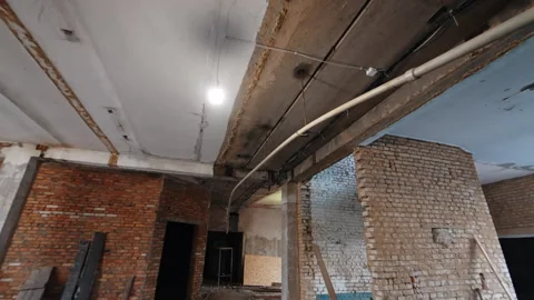 Plastic pipe hanging on the ceiling along with the light wire and bulb. Stock Footage 292933889