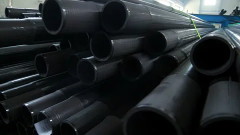 Plastic pipe stack industrial warehouse. Close up camera pan HDPE tube ends. Stock Footage 345612561