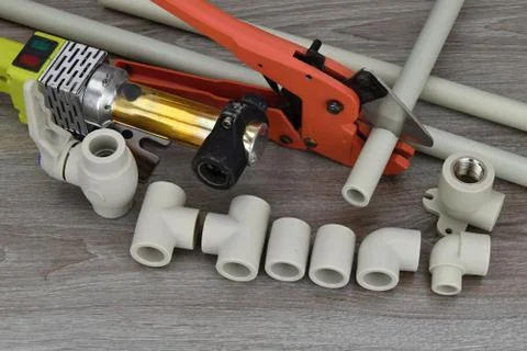 Plastic pipe welder. Components making water pipes and special scissors for c Stock Photos