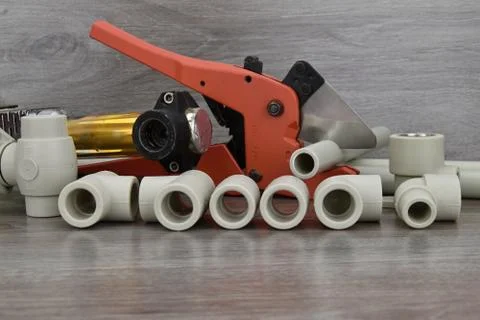 Plastic pipe welder. Components making water pipes and special scissors for c Stock Photos