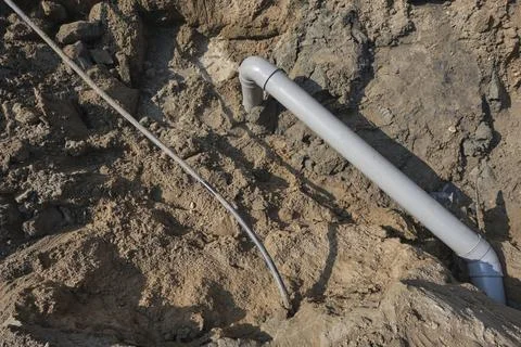 Plastic pipes in the ground during the construction of a building Stock Photos