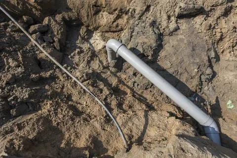 Plastic pipes in the ground during the construction of a building Stock Photos