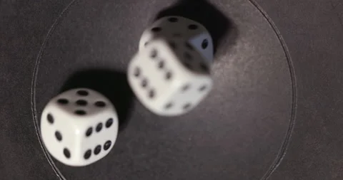 Plastic playing gambling dice rolling forever against dark background Vidéo 166245399