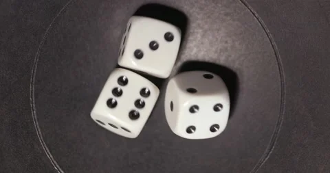 Plastic playing gambling dice rolling forever against dark background Vidéo 167211664
