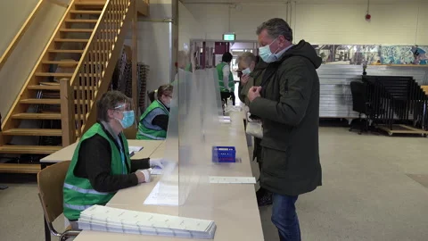 Plastic (plexi glass) screens and face masks, national elections Netherlands Video stock 151473449