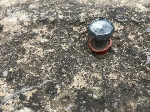 Plastic plug with hex head screw anchored to a concrete wall Stock Photos