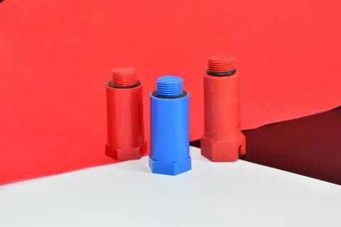 Plastic plugs for hot and cold water pipes. Stock Photos