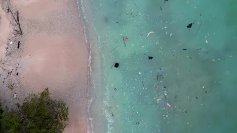 Plastic pollution accumulating in ocean and on beach. Nice aerial view drone Stock Footage 344606803