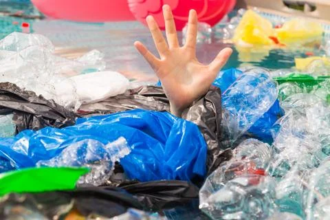 Plastic pollution and environmental problem, man's hand in plastic sea Stock Photos