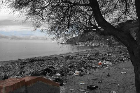 Plastic pollution and tires garbage on sea beach environmental disaster Stock Photos
