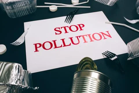 Plastic pollution concept. Close-up of paper with words Stop Pollution near Stock Photos