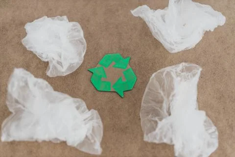 Plastic pollution concept, group of plastic bags with green recycle symbol Stock Photos