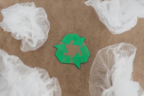 Plastic pollution concept, group of plastic bags with green recycle symbol Stock Photos