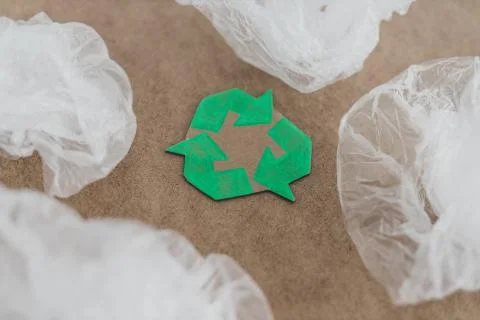 Plastic pollution concept, group of plastic bags with green recycle symbol Stock Photos