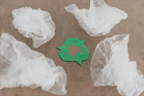 Plastic pollution concept, group of plastic bags with green recycle symbol Stock Photos