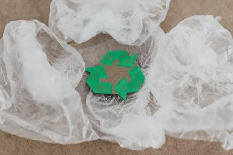 Plastic pollution concept, group of plastic bags with green recycle symbol Stock Photos