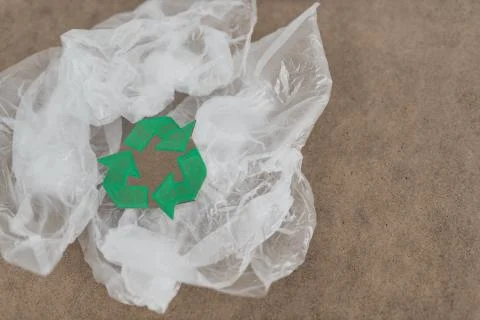 Plastic pollution concept, group of plastic bags with green recycle symbol Stock Photos