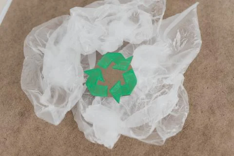 Plastic pollution concept, group of plastic bags with green recycle symbol Stock Photos