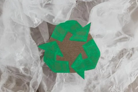 Plastic pollution concept, group of plastic bags with green recycle symbol Stock Photos