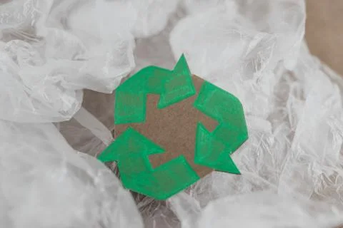 Plastic pollution concept, group of plastic bags with green recycle symbol Stock Photos