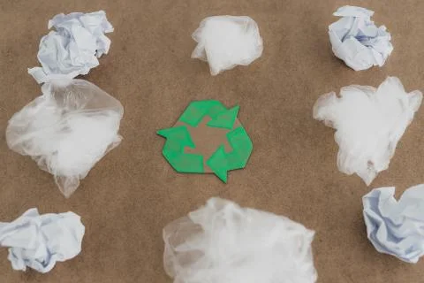 Plastic pollution concept, group of plastic bags with green recycle symbol Stock Photos